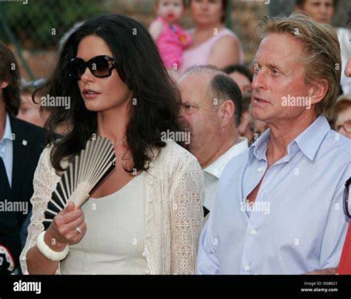 Actors Michael Douglas and Catherine Zeta Jones sit together at ringside before the start of the WBC/IBF Welterweight Championship fight between Oscar De La Hoya and Felix Trinidad at the Mandalay Bay Events Center in Las Vegas Saturday, Sept. 18, 1999. (AP Photo/Kevork Djansezian)