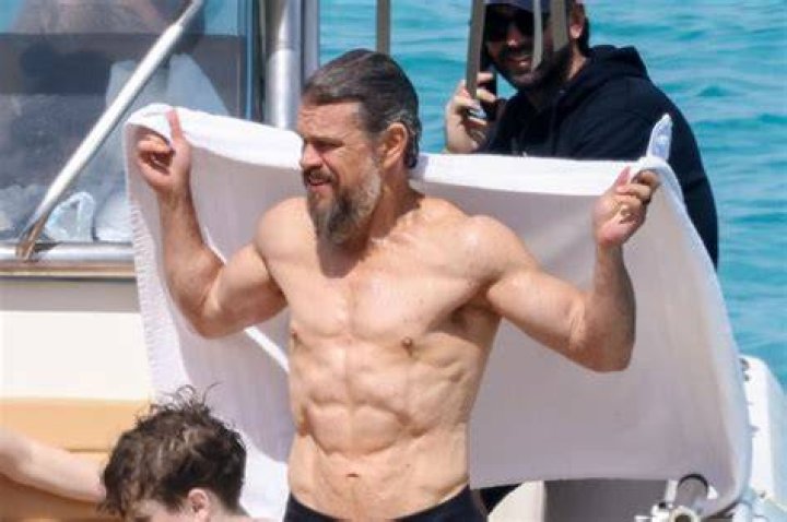 Matt Damon smiles while shirtless