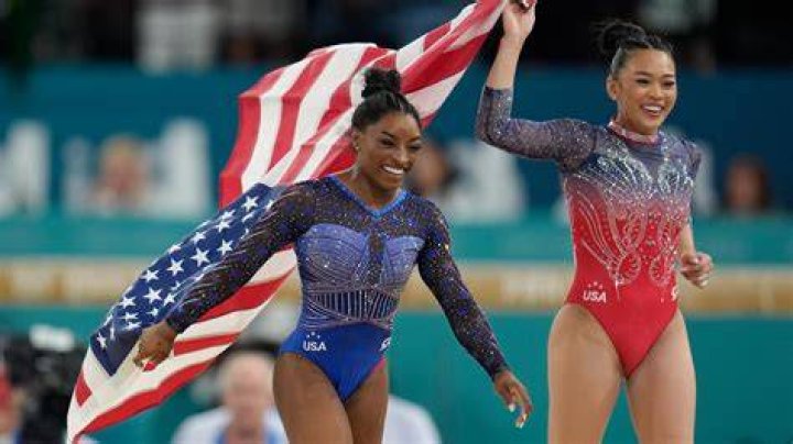 Simone Biles walks to her gate for her flight to the Summer Olympic Games in Tokyo as United Airlines employees wave flags during a send-off event for the U.S. Women's Gymnastics team at the San Francisco International Airport onUS Gymnastics Biles, San Francisco, United States - 14 Jul 2021